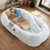 A human-specific dog bed featuring a washable faux fur design