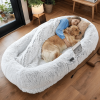 A human-specific dog bed featuring a washable faux fur design